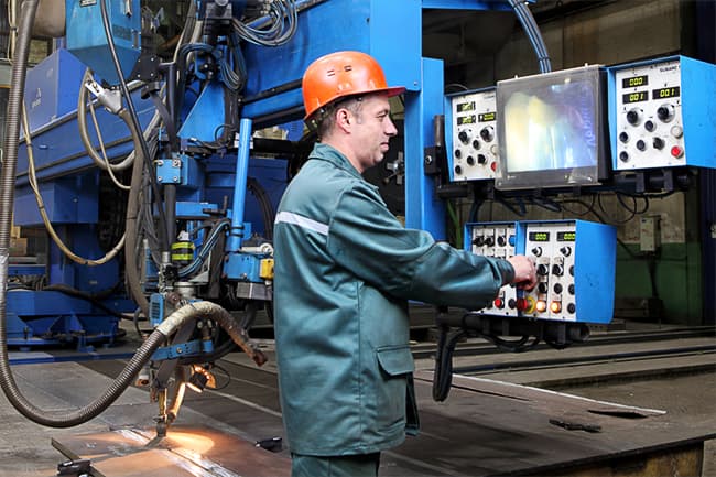 worker operating a SAW machine