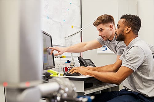2 Technicians Programming a CMM