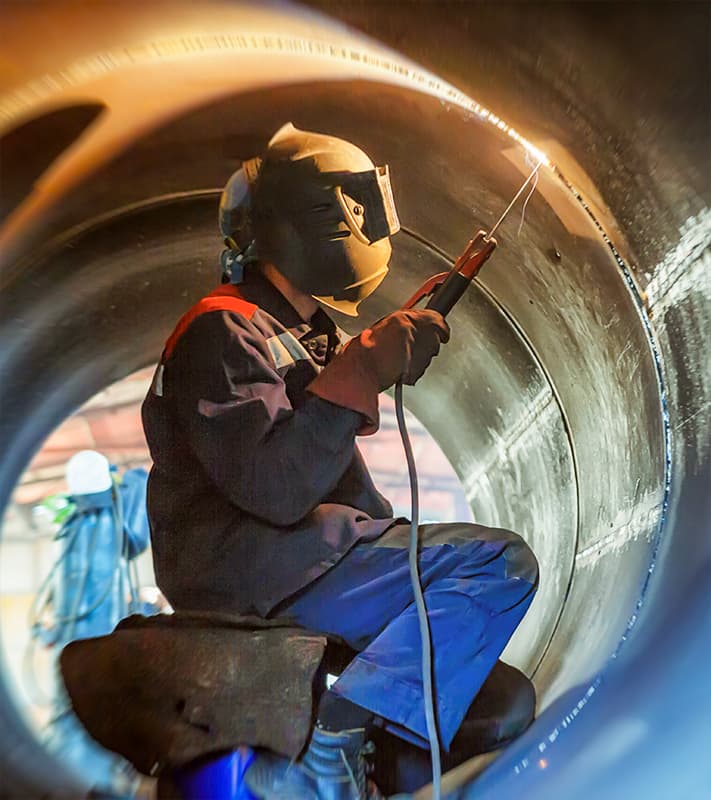 welding a pipe using SMAW.