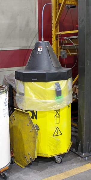 Container of welding wire fed into a robotic welding station.